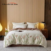Cream egyptian cotton bedding set with delicate pink and green tulip embroidery on a cream-colored duvet cover