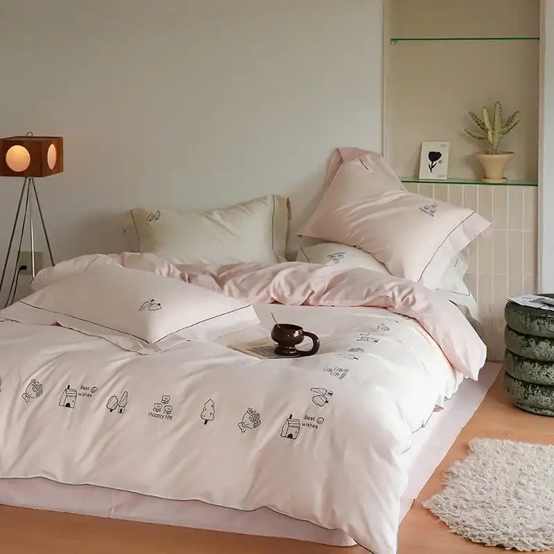 Cream embroidered brushed volcanic fleece bedding set in pastel pink and white with black tree and house illustrations