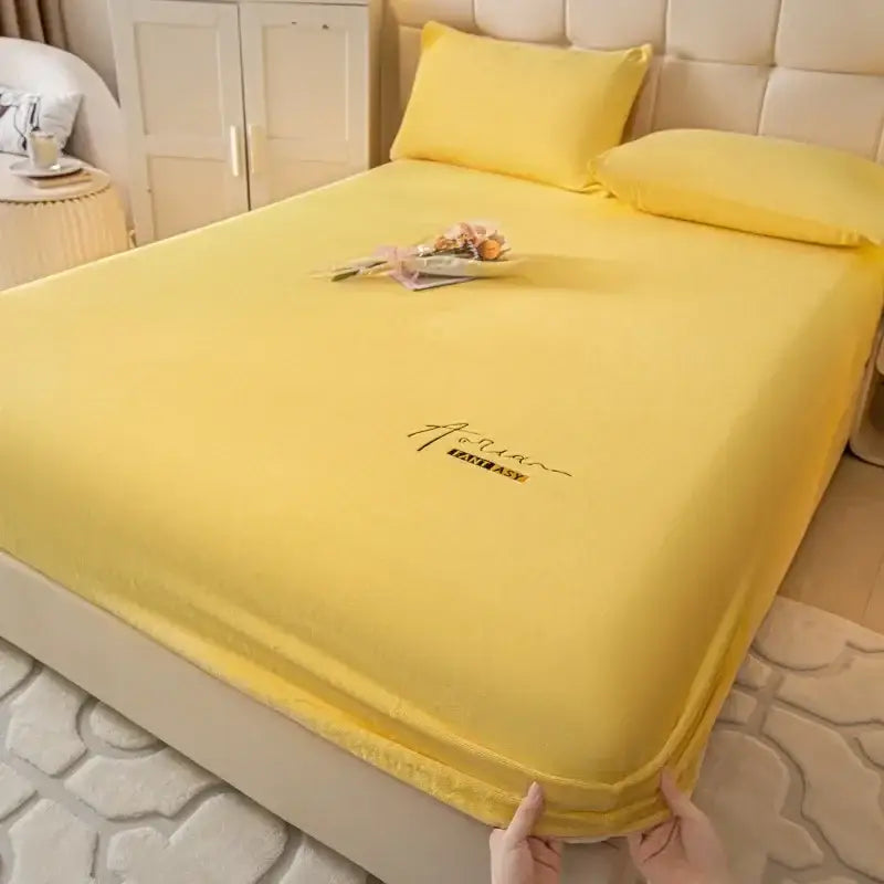 Bright yellow cozy velvet fitted sheet with subtle embroidered logo center by decorbites for bedroom bed cover