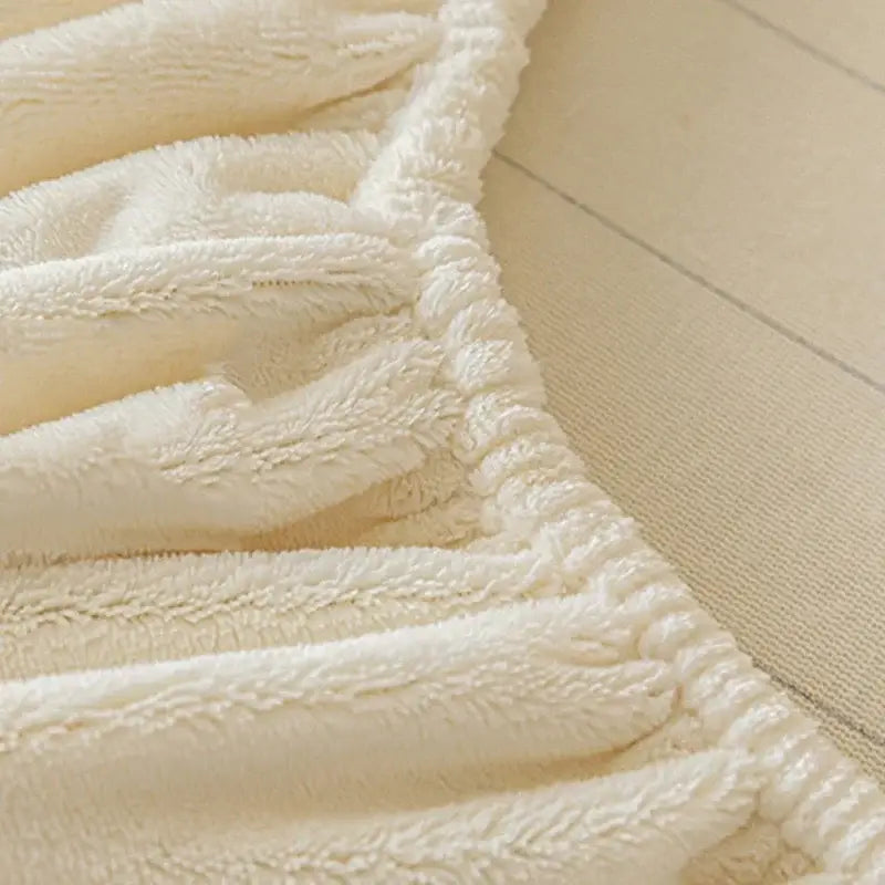 Cream embroidered cozy velvet fitted sheet with a cream plush textured surface and ribbed edge for bedroom use