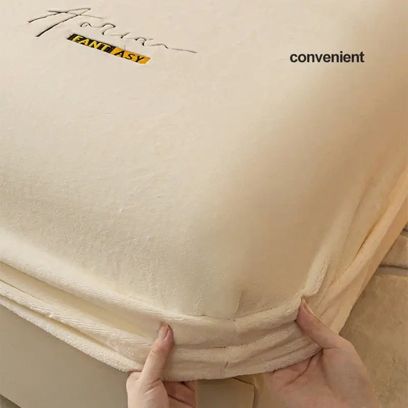 Cream cream-colored plush mattress protector with embroidered fantasy branding for decorbites cozy velvet fitted use