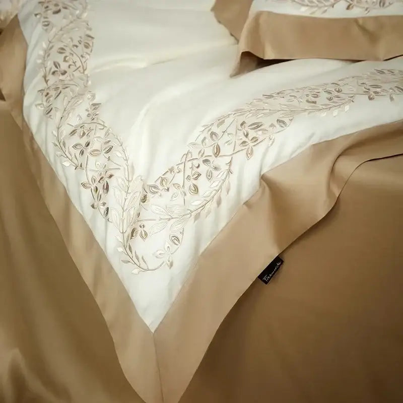 Cream embroidered egyptian cotton bedding set with cream satin bedspread and silver thread leafy vine embroidery along edge
