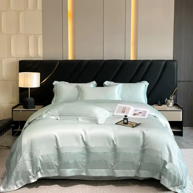 Light blue satin duvet set with subtle stitching in an embroidered ice silk bedding set for bedroom use
