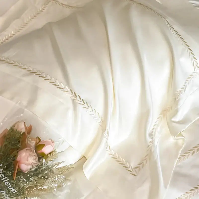 Cream embroidered ice silk bedding set featuring luxurious cream satin fabric with delicate gold leaf embroidery edges