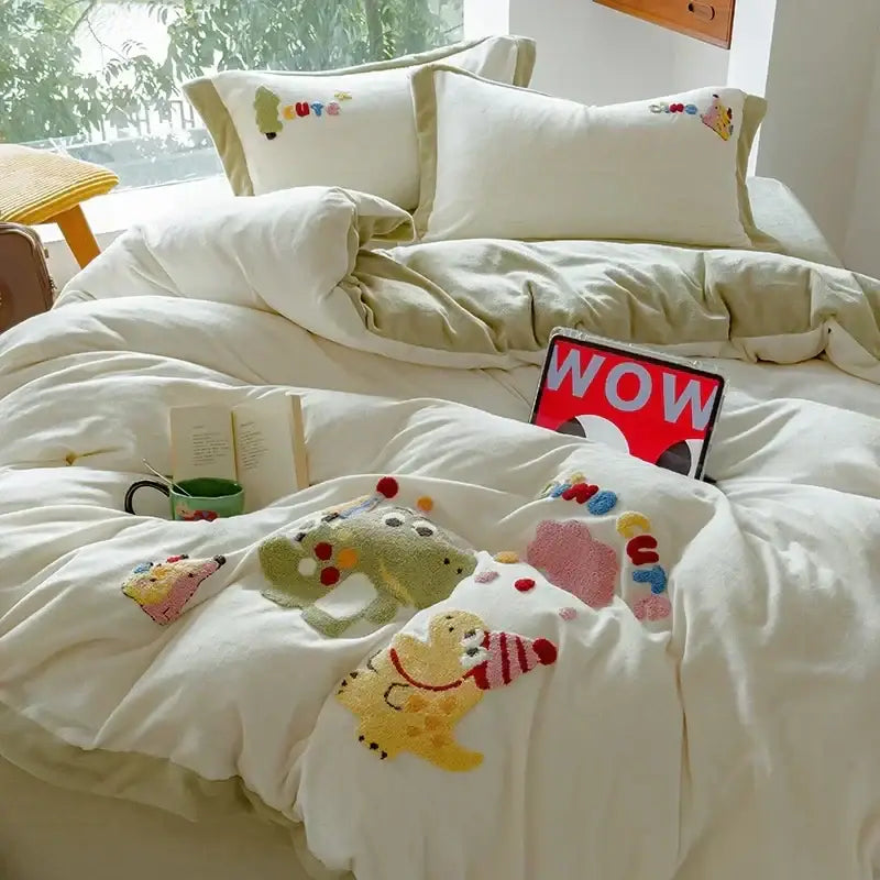 Cream embroidered milk fleece bedding set with plush duvet featuring cartoon dinosaurs and colorful pom-pom accents