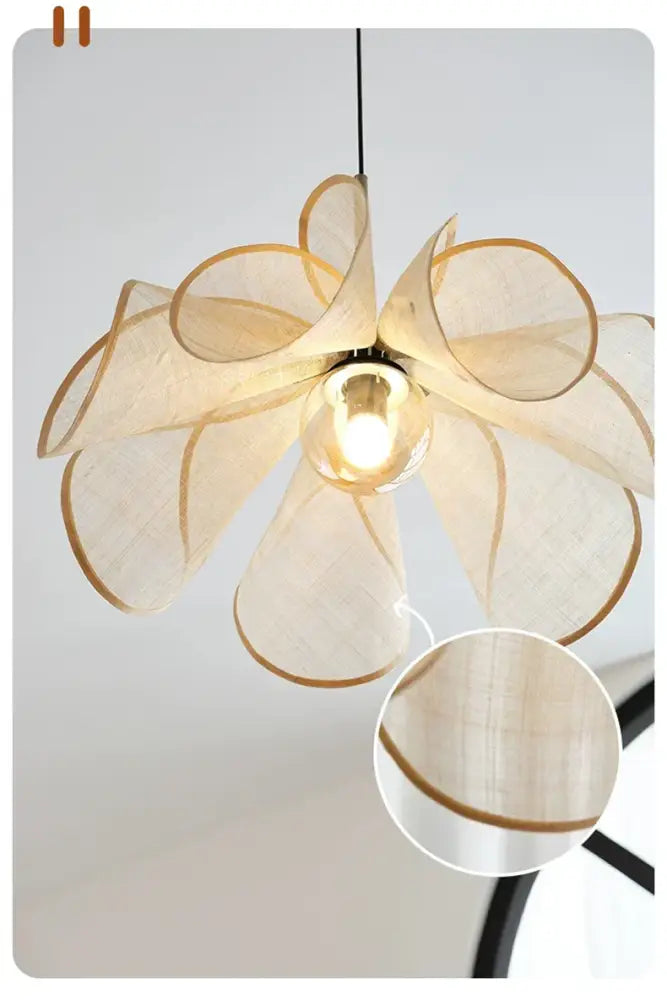 Cream fabric flower chandelier featuring a delicate fabric flower pendant light with gold-trimmed petals and central bulb