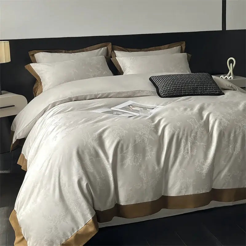 Cream floral jacquard bedding set featuring cream-colored satin duvet cover with subtle embroidery and gold-toned trim