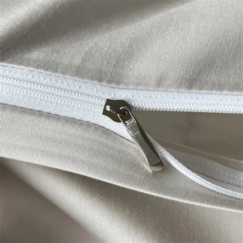 Cream floral jacquard bedding set with a silver-toned zipper and metallic pull tab on smooth white fabric decorbites jacquard bedding