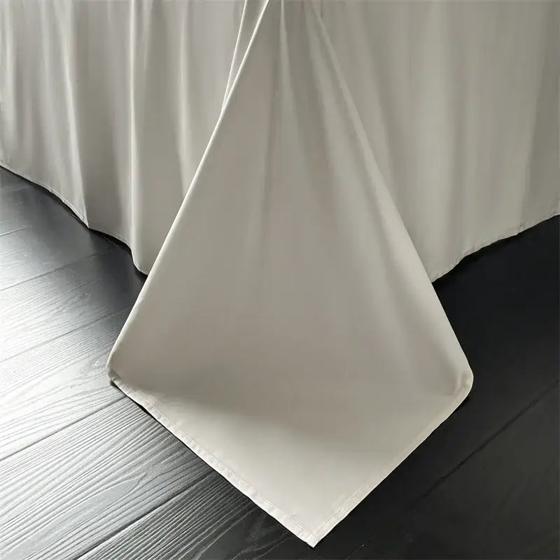 Cream floral jacquard bedding set features an off-white satin quilt cover draped over a dark wooden surface by decorbites jacquard bedding