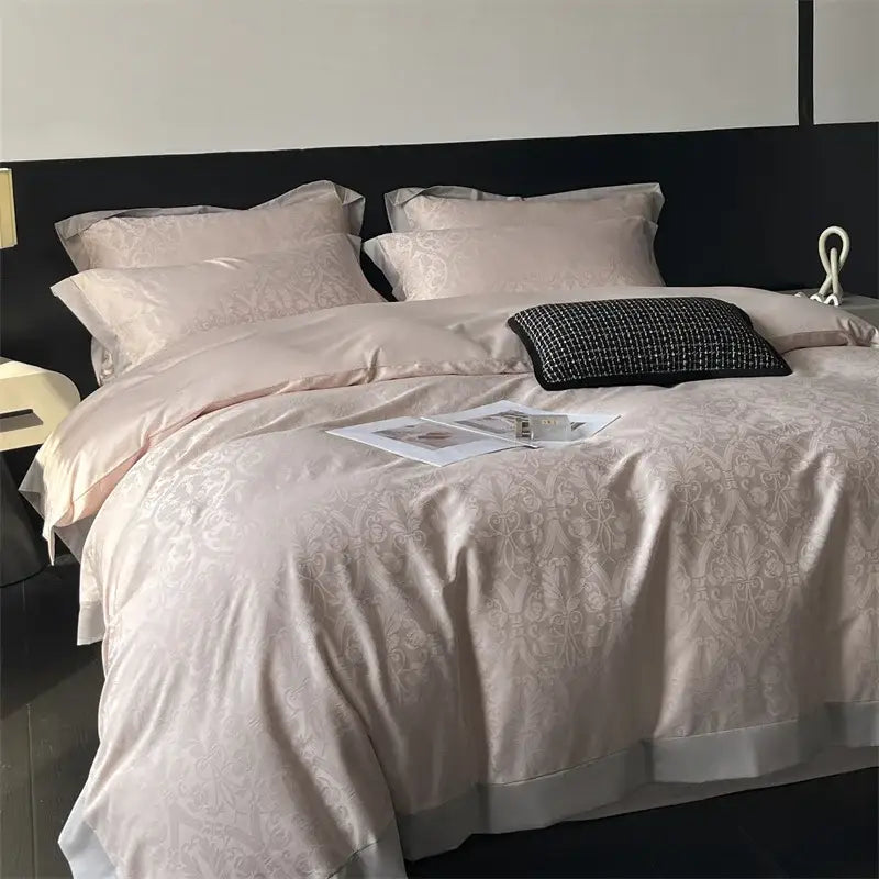 Cream floral jacquard bedding set featuring a soft blush pink satin duvet cover with subtle damask pattern and white hem