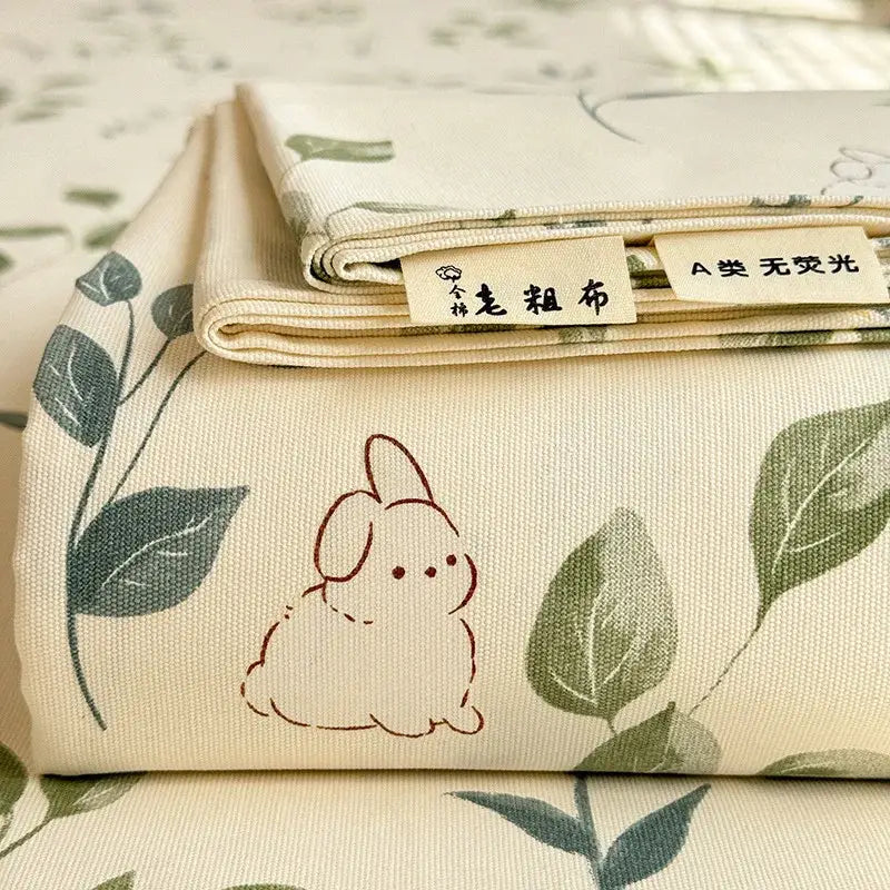 Beige cotton bed cover with cream flower print featuring subtle green leaves and brown bunny decorbites cooling cotton