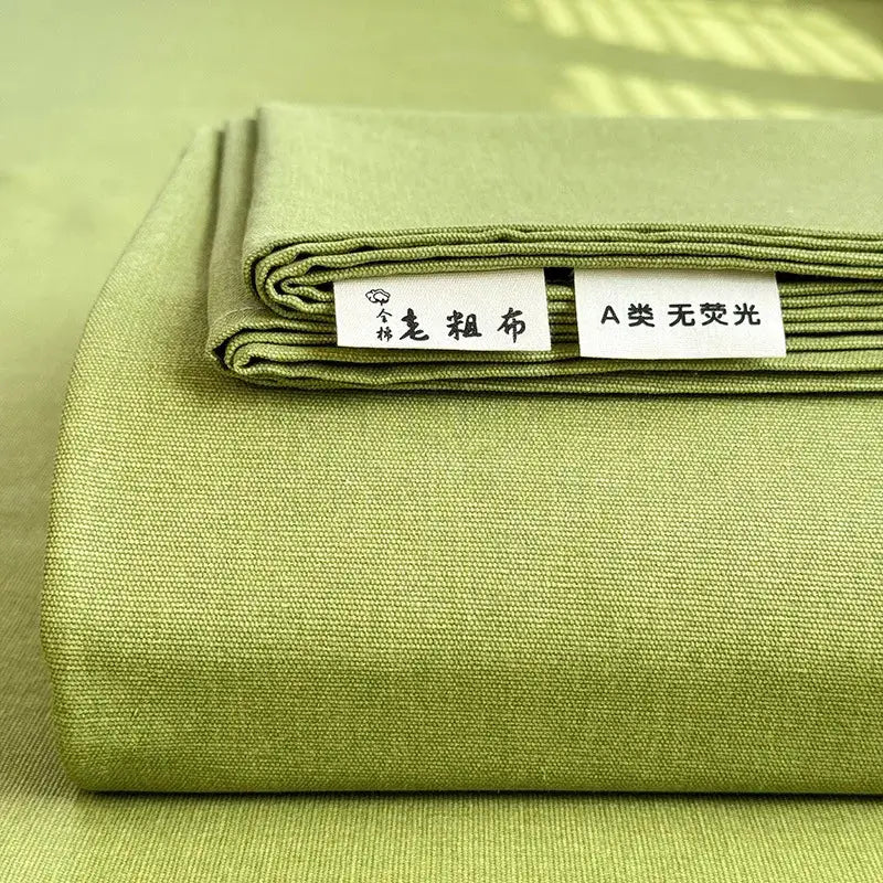 Neatly folded olive-green cotton fabric with textured weave and stitching for decorbites cooling cotton bed cover protector