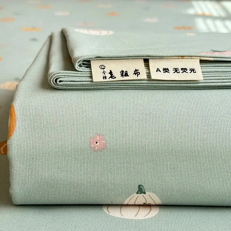 A soft mint-green cotton bed cover with subtle embroidered pumpkins and flowers flower print by decorbites cooling cotton
