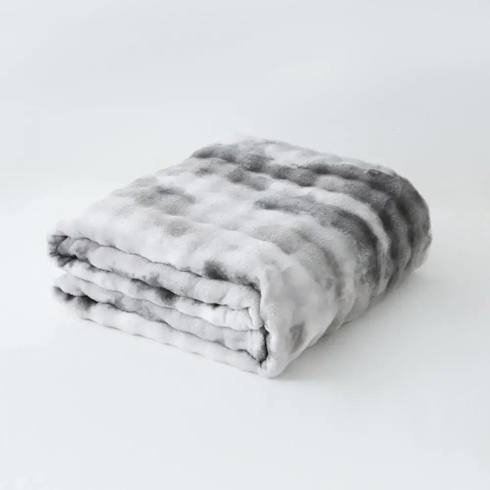 A gray and white mottled decorbites fuzzy faux fur blanket with soft texture for bedroom and living room throw