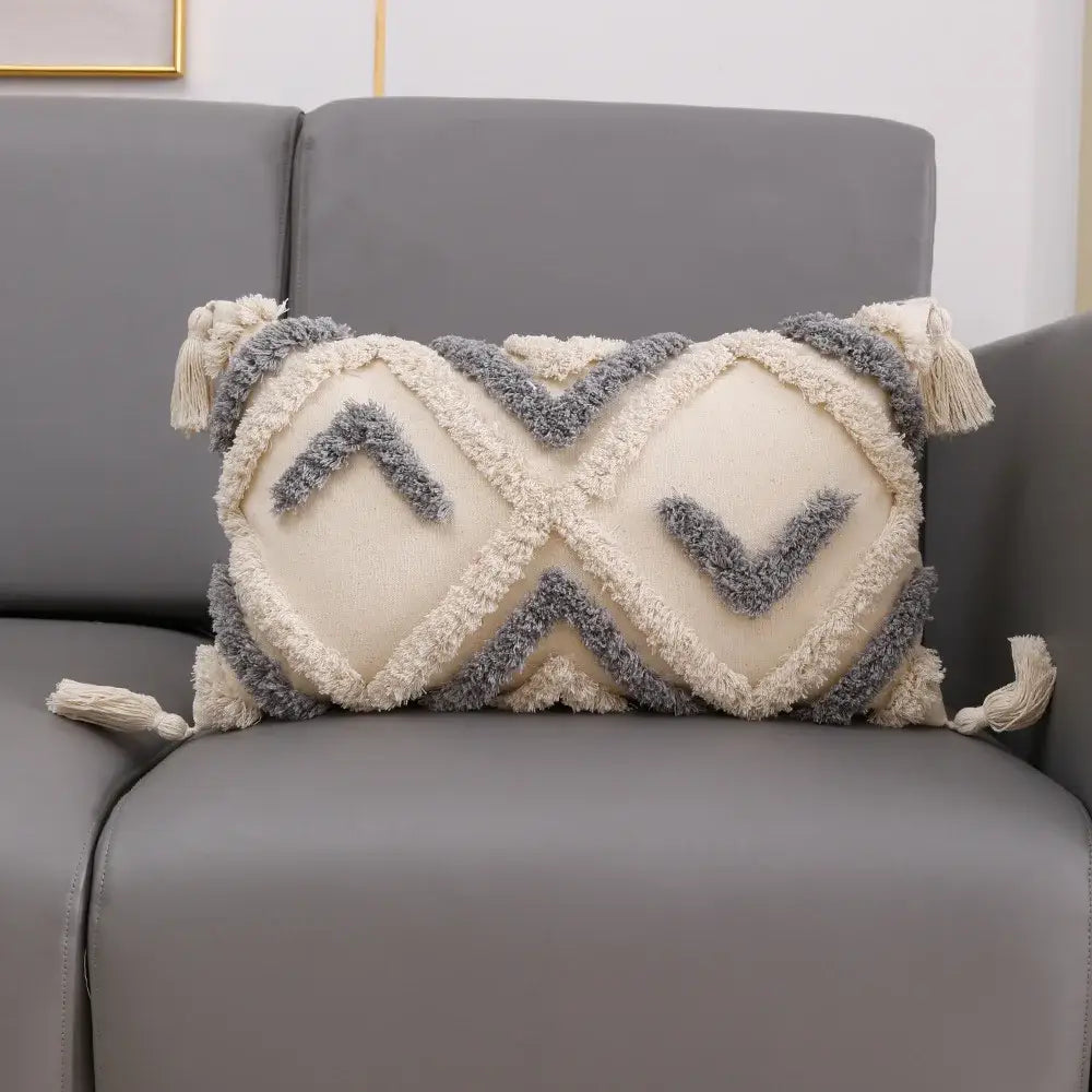 Cream and gray textured cushion cover with geometric embroidery and tassel accents for living room decorbites decor