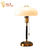 Brass-finished table lamp with cream glass mushroom shade and black textured column for decorbites cream glass decor