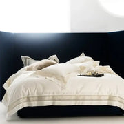 Cream-colored satin bedding set with gold wide edge embroidery on dark navy bed decorbites bedding set two sizes