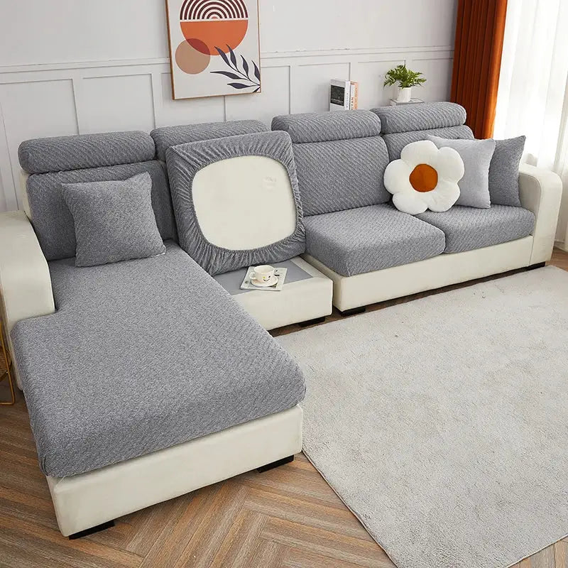 Gray textured cream jacquard l sofa cover with elasticized edges and white circular cutout on backrest showing back side