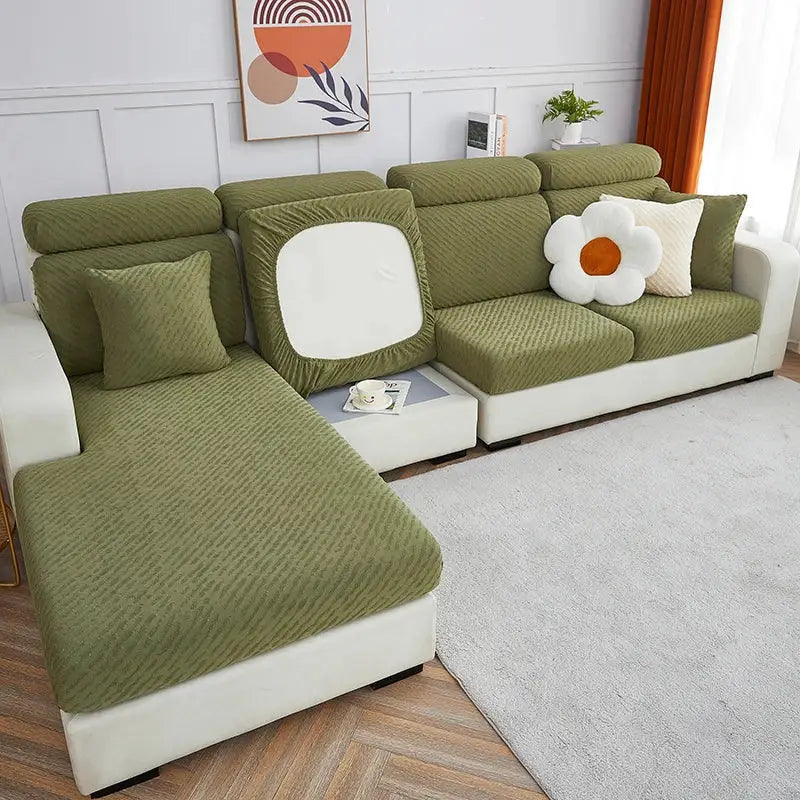 Olive green textured jacquard l sofa seat cover with a white square cutout on the backrest and matching cushions