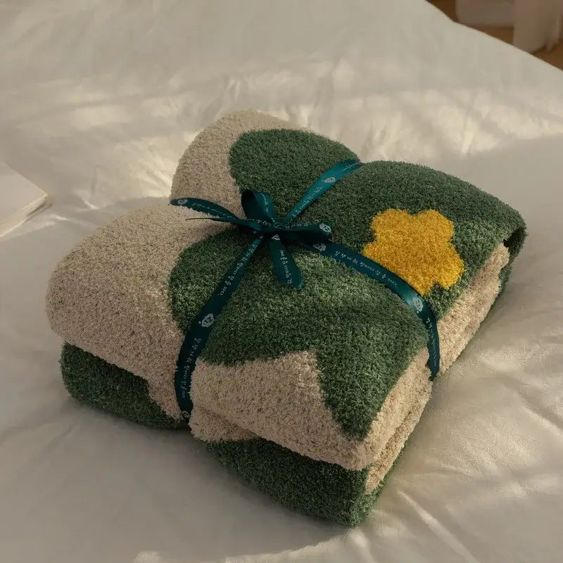 A plush two toned green and beige korean kawaii flower towel set with yellow appliqué tied with a teal ribbon decorbites