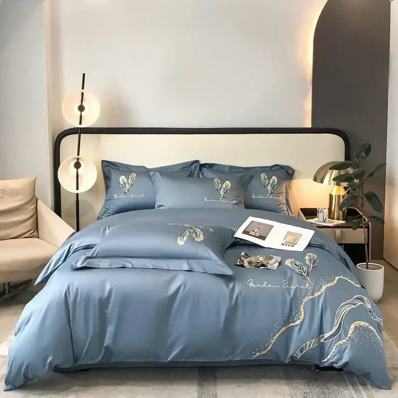 Blue satin-like bed linens set with gold-traced floral cream leaf cotton embroidery for elegant bedroom decorbites decor