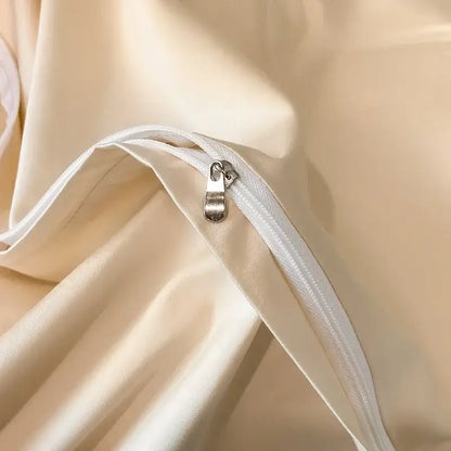 Cream-colored satin pillowcase with white zipper and metallic pull tab in decorbites cotton embroidery bed linens set