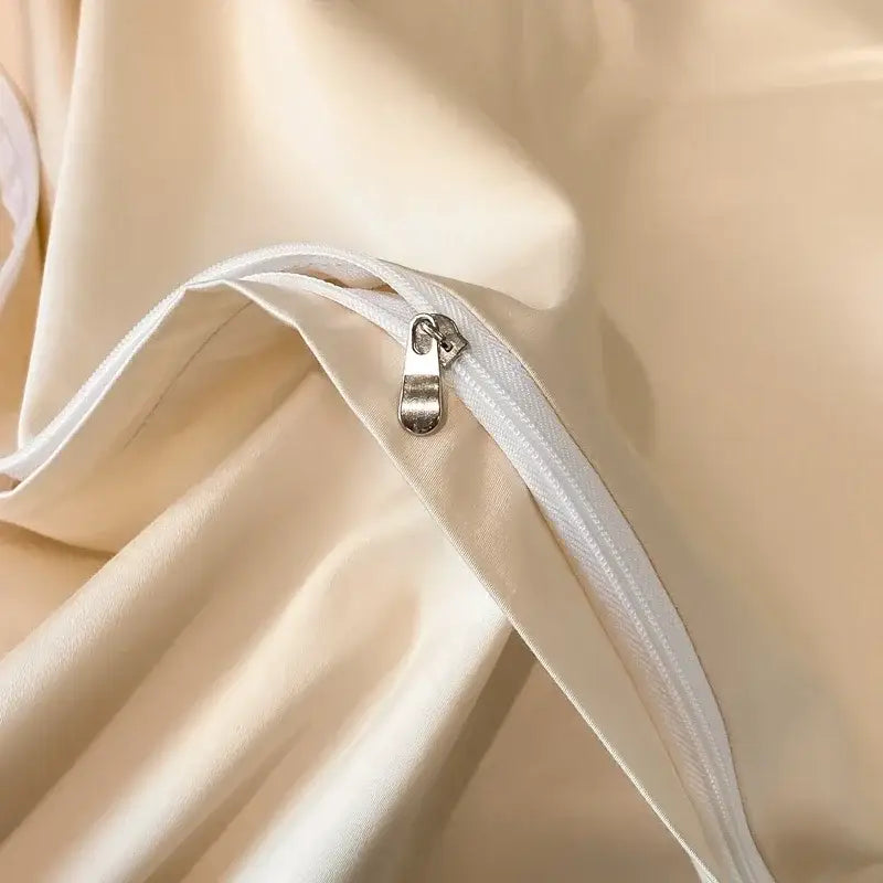 Cream-colored satin pillowcase with white zipper and metallic pull tab in decorbites cotton embroidery bed linens set