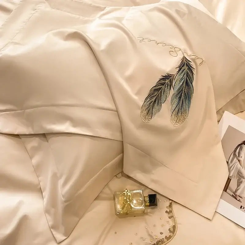 Cream satin pillowcase with intricate green and gold embroidered feathers in decorbites cotton embroidery bed linens set