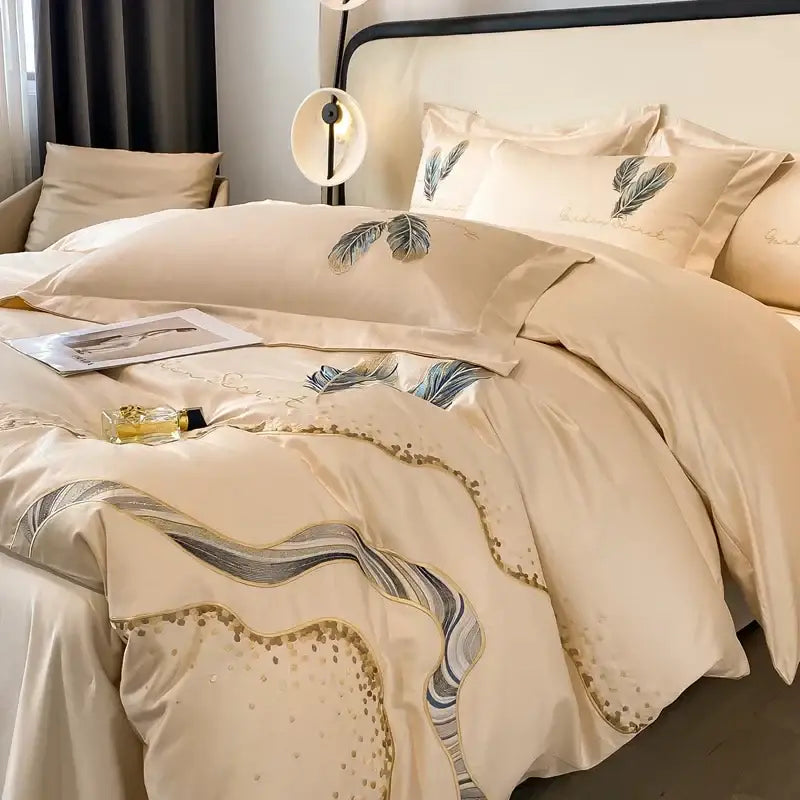 Cream-colored satin cotton embroidery bed linens set with elegant feather embroidery and gold thread accents for decorbites decor