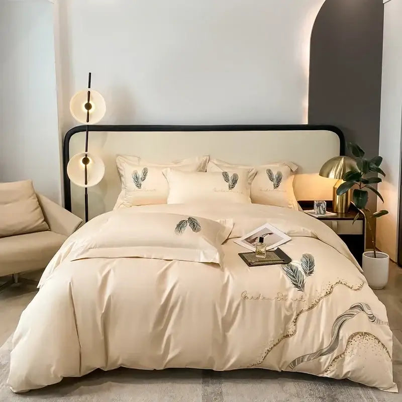 Cream bed linens set featuring cotton embroidery with delicate leaf design and gold thread accents for elegant decorbites decor