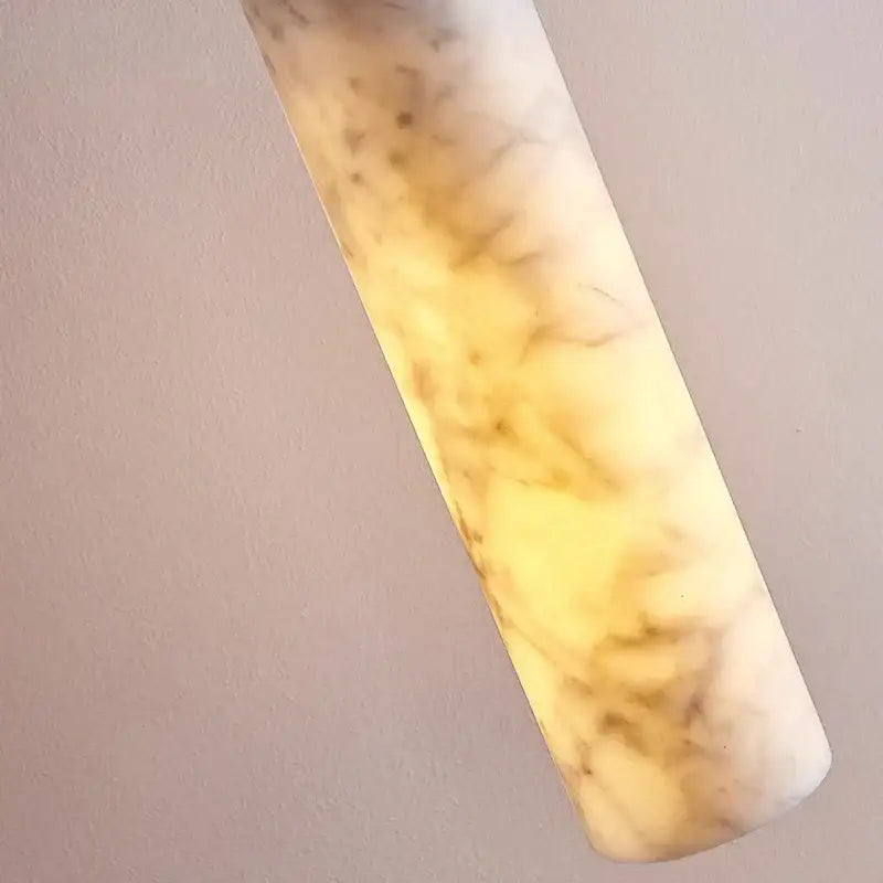 Cream marble cylinder pendant light with translucent warm yellow and beige lampshade for luxury bedroom decorbites cream marble