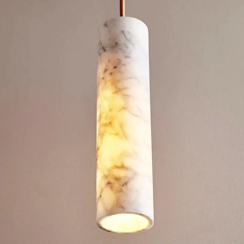Cream marble cylinder pendant light with warm glowing interior for luxury bedroom and bar counter decorbites cream marble
