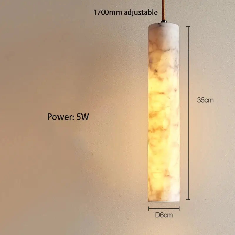 Cream marble cylinder pendant light with warm amber glowing finish for luxury bedroom and bar counter decorbites cream marble