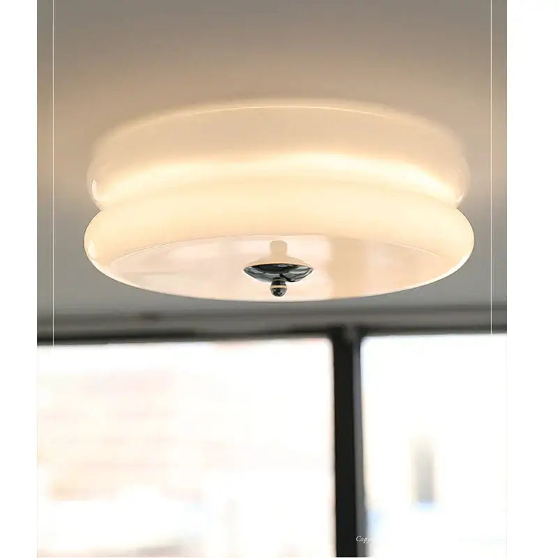 A sleek cream medieval glass ceiling lamp with a frosted circular design and central metallic fixture for living room decorbites ceiling lamp