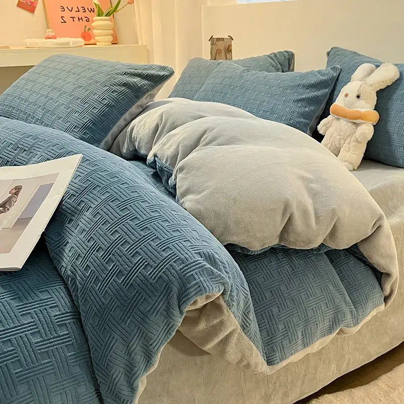 Blue textured comforter with soft plush gray lining as part of a cozy cream and mustard quilted duvet cover set