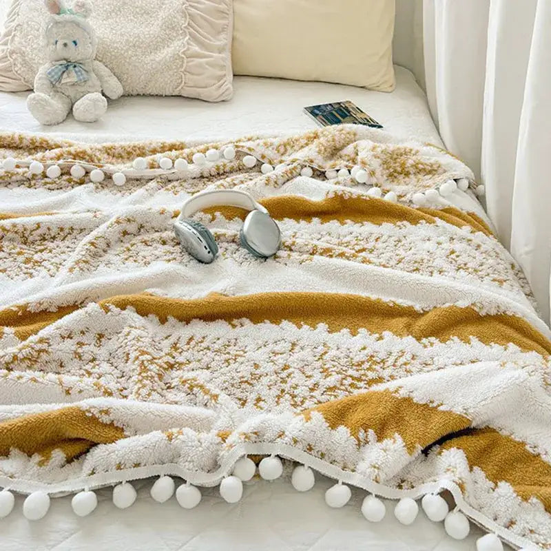Cream and mustard yellow decorbites jacquard fluffy living room blanket with textured stripes and fluffy ball lace edges