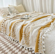 Cozy cream and mustard yellow jacquard fluffy ball lace throw blanket with white pom-pom trim for living room decorbites