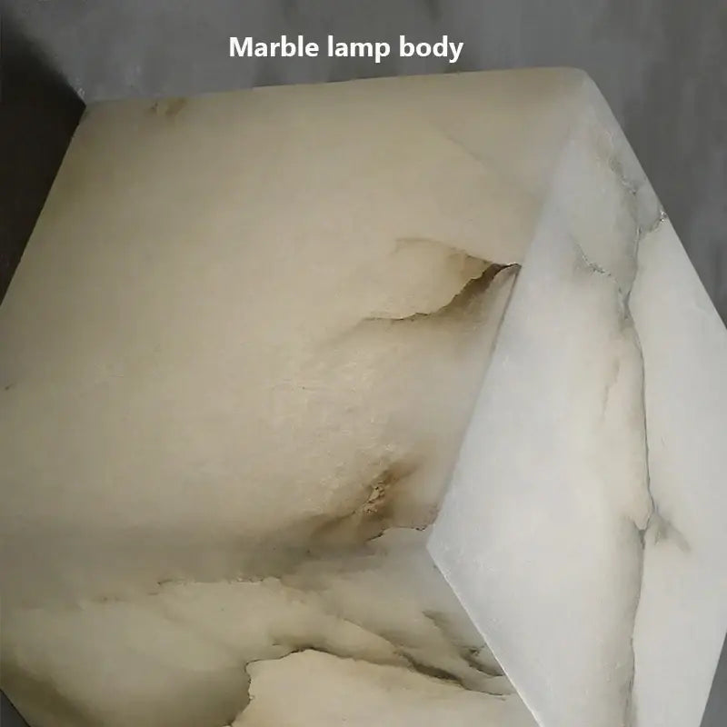 Cream onyx marble cube led wall sconce with cream-colored polished marble body and subtle veining for bedroom lighting