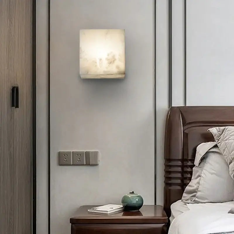 Cream onyx marble cube led wall sconce with translucent white finish softly glowing for bedroom lighting