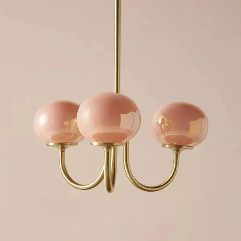 Delicate decorbites cream pink pendant light with three rose-tinted glass globes and polished brass frame for bedroom decor