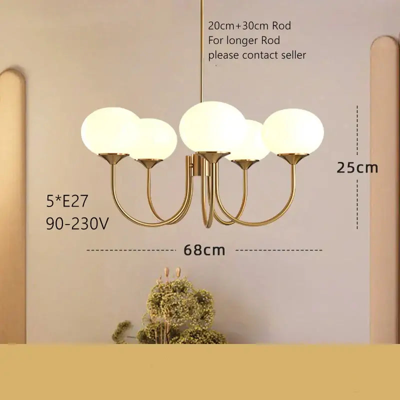 Gold-toned modern pendant light with five frosted glass globes for decorbites cream pink bedroom decor
