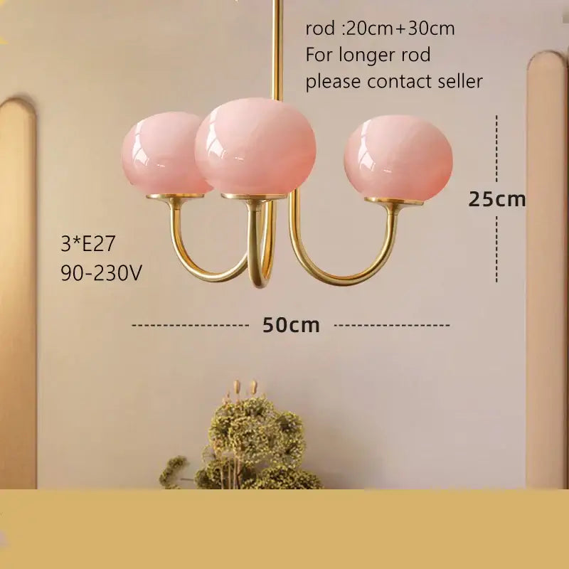 Cream pink bedroom pendant light with three glass globes and gold-toned metal arms by decorbites cream pink