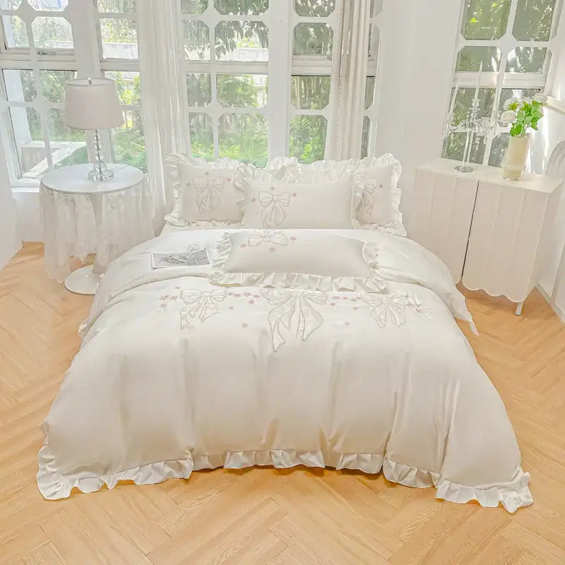 Cream-colored satin duvet set with white embroidered ruffles and bows in ice silk for elegant bedroom bedding