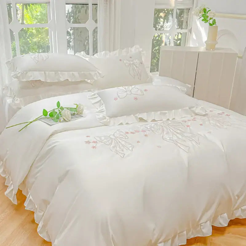 Cream and pink ice silk duvet set with white satin-like fabric featuring delicate embroidered ruffles and bows