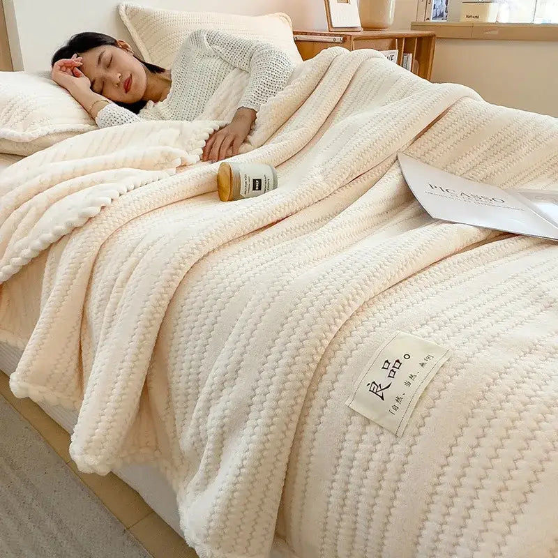 Cream plush double sided jacquard milk velvet blanket featuring a textured ribbed knit pattern and soft cozy appearance