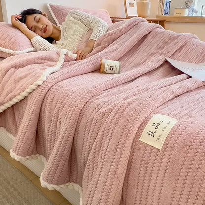 Pink textured knit blanket with white braided trim featuring soft double sided jacquard milk velvet fabric for bedroom throw