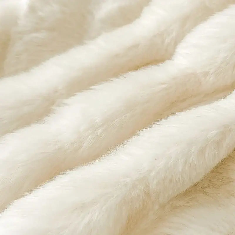 Cream plush rabbit fur bedding set featuring a cream-colored faux fur blanket with plush soft texture and gentle waves
