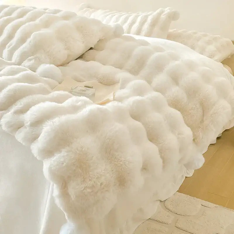 Cream plush rabbit fur bedding set with white fluffy faux fur and textured cloud-like design for luxury bedroom use
