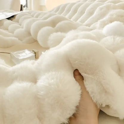 Cream plush rabbit fur bedding set featuring a white faux fur throw blanket with soft wavy texture and luxurious feel
