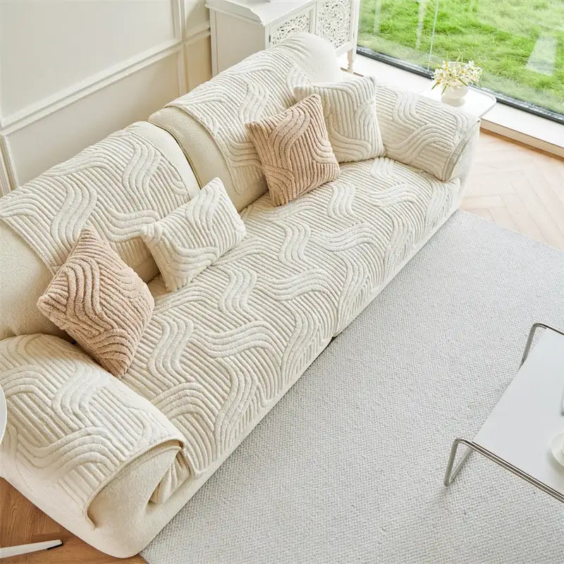 Cream quilted wave plush sofa cover in cream with velvety texture and matching beige throw pillows for living room